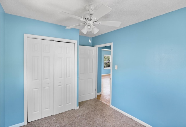 217 E Park Ave, Des Moines, IA 50315 - unfurnished bedroom with carpet, a closet, and a ceiling fan
