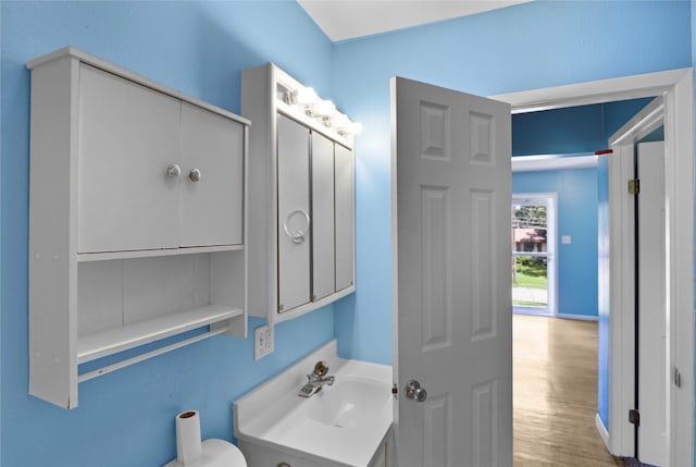 217 E Park Ave, Des Moines, IA 50315 - half bath with wood finished floors and vanity
