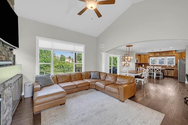 1965 SE Waddell Way, Waukee, IA 50263 - living room featuring dark wood-style floors, ceiling fan, arched walkways, a chandelier, and high vaulted ceiling