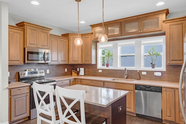 1965 SE Waddell Way, Waukee, IA 50263 - kitchen with appliances with stainless steel finishes, light countertops, backsplash, and recessed lighting