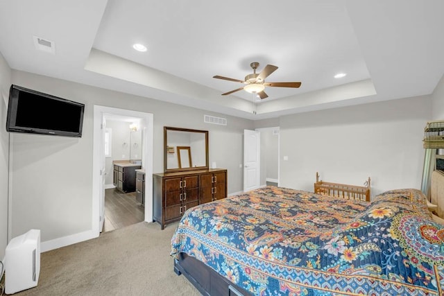 1965 SE Waddell Way, Waukee, IA 50263 - bedroom featuring a raised ceiling, light carpet, recessed lighting, ceiling fan, and ensuite bathroom