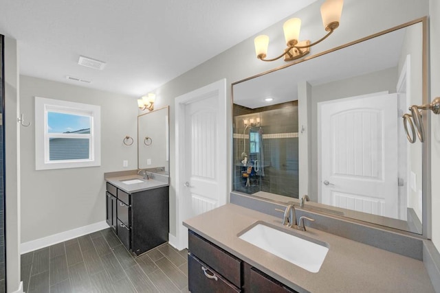 1965 SE Waddell Way, Waukee, IA 50263 - bathroom with two vanities, a tile shower, and a chandelier