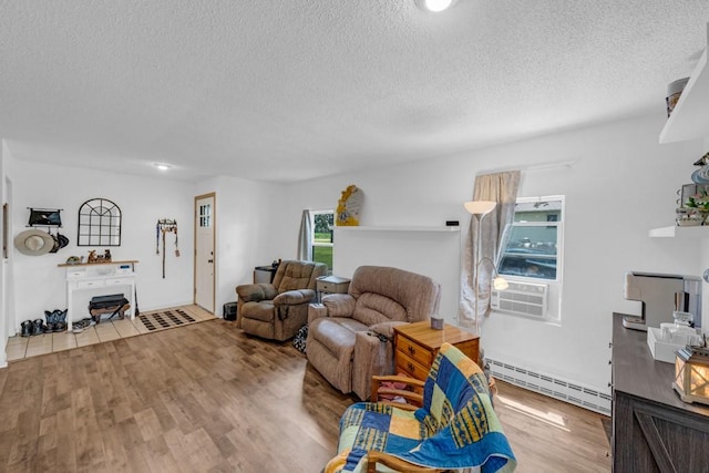 1020 SW 3rd St, Nevada, IA 50201 - living area with a baseboard radiator, a textured ceiling, wood finished floors, and cooling unit