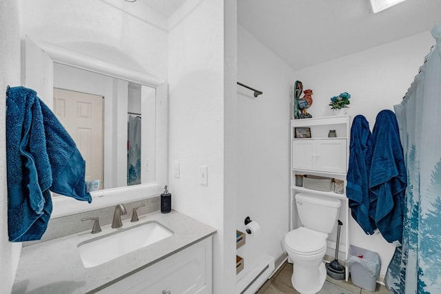 1020 SW 3rd St, Nevada, IA 50201 - full bathroom with vanity, a shower with shower curtain, tile patterned flooring, and a baseboard heating unit