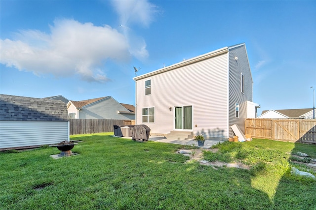 3504 Hawthorn Dr SW, Bondurant, IA 50035 - rear view of house with a fenced backyard, entry steps, a fire pit, and a storage unit