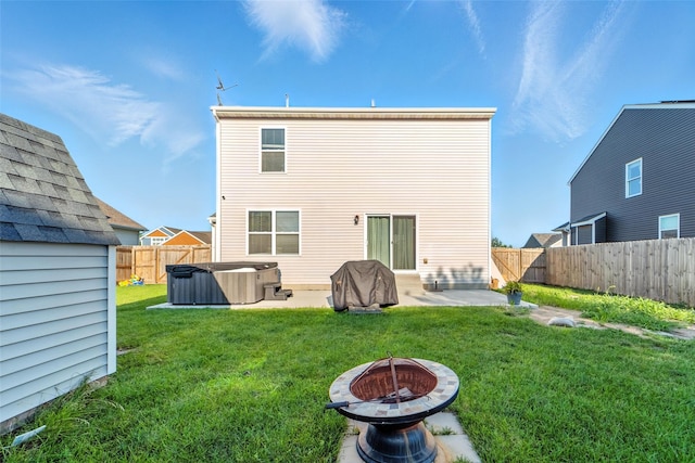 3504 Hawthorn Dr SW, Bondurant, IA 50035 - rear view of property featuring a hot tub, a patio, a fenced backyard, and a fire pit