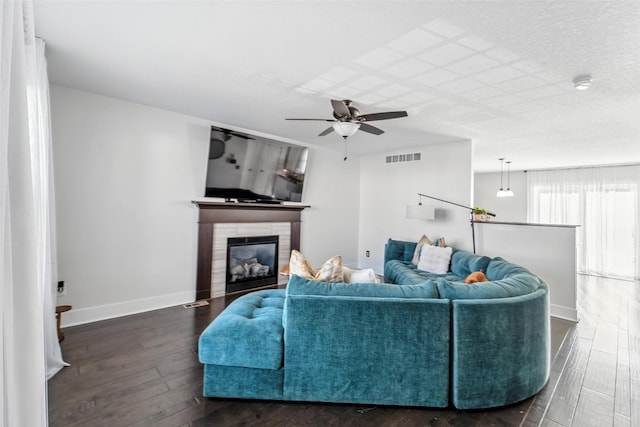 3504 Hawthorn Dr SW, Bondurant, IA 50035 - living area with dark wood-style floors, a ceiling fan, and a glass covered fireplace