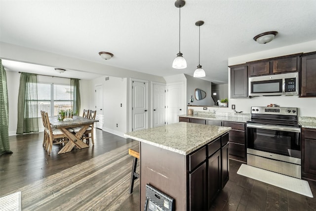 3504 Hawthorn Dr SW, Bondurant, IA 50035 - kitchen with stainless steel appliances, dark wood-style flooring, dark brown cabinets, a center island, and pendant lighting