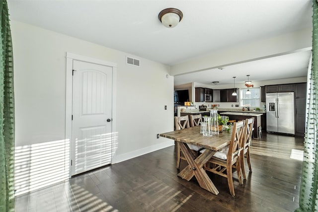 3504 Hawthorn Dr SW, Bondurant, IA 50035 - dining room featuring dark wood-style floors and baseboards