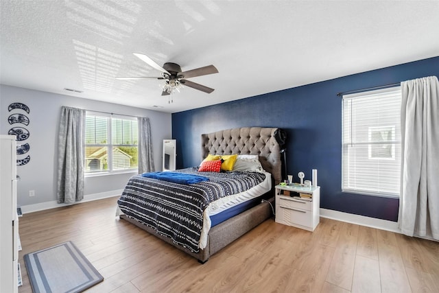 3504 Hawthorn Dr SW, Bondurant, IA 50035 - bedroom featuring light wood-type flooring, ceiling fan, and a textured ceiling