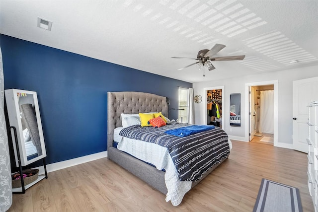 3504 Hawthorn Dr SW, Bondurant, IA 50035 - bedroom featuring wood finished floors, a ceiling fan, and a spacious closet