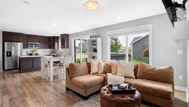 1208 NE 21st St, Grimes, IA 50111 - living area featuring light wood-style flooring and recessed lighting