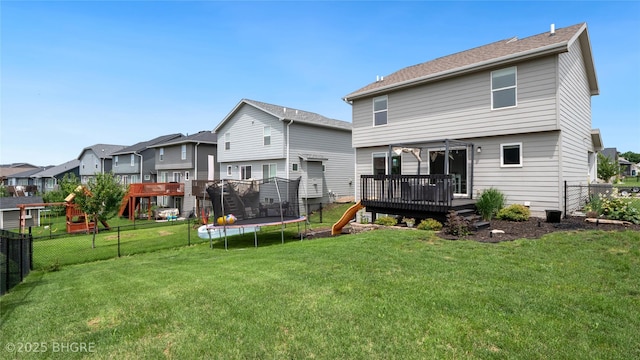 1208 NE 21st St, Grimes, IA 50111 - rear view of property featuring a trampoline, a deck, a fenced backyard, a residential view, and a playground
