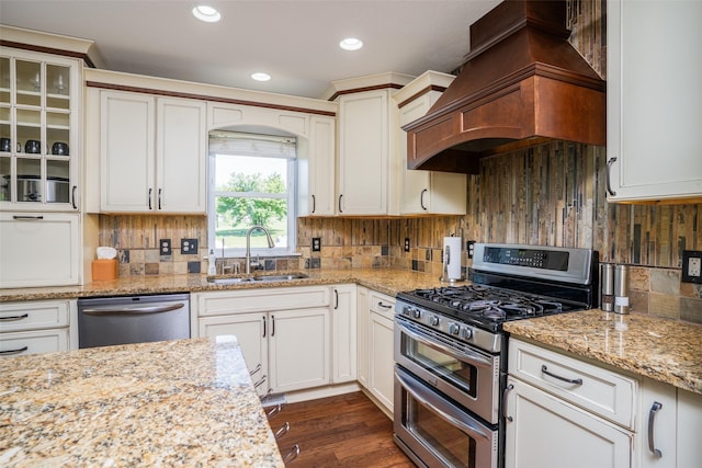 4785 Windsor Cir, Pleasant Hill, IA 50327 - kitchen featuring appliances with stainless steel finishes, premium range hood, decorative backsplash, light stone counters, and recessed lighting