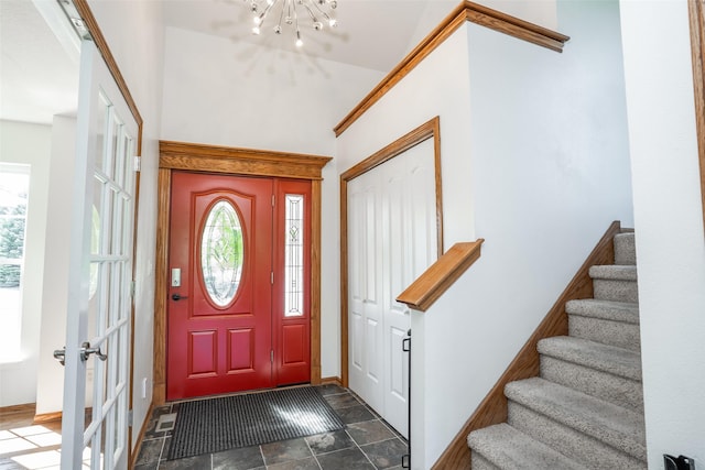 4785 Windsor Cir, Pleasant Hill, IA 50327 - entryway with a chandelier, stairway, and dark stone finish flooring