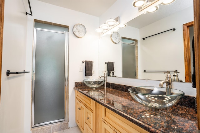 4785 Windsor Cir, Pleasant Hill, IA 50327 - full bathroom featuring a stall shower, double vanity, and tile patterned flooring