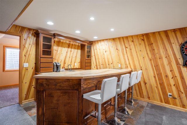 4785 Windsor Cir, Pleasant Hill, IA 50327 - indoor bar featuring wood walls, recessed lighting, and dark stone finish floors