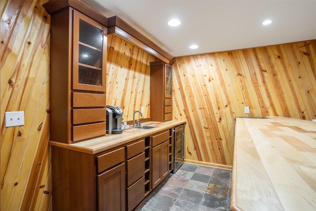 4785 Windsor Cir, Pleasant Hill, IA 50327 - bar featuring dark stone finish floors, wood walls, and recessed lighting