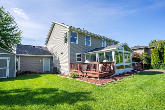 4785 Windsor Cir, Pleasant Hill, IA 50327 - rear view of house with a sunroom, a yard, a deck, and a storage shed