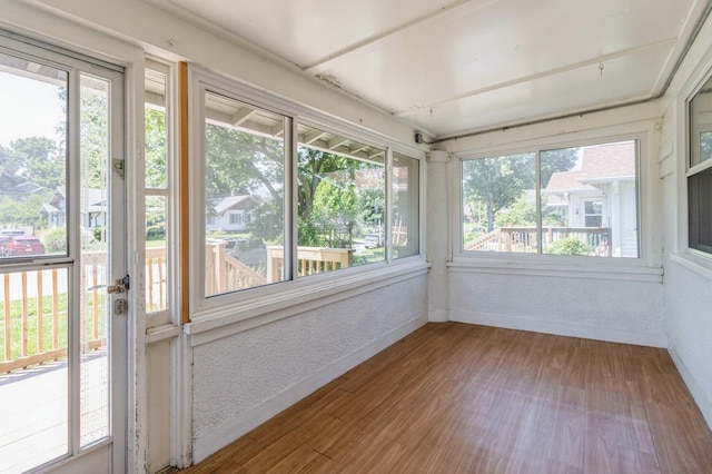 849 39th St, Des Moines, IA 50312 - unfurnished sunroom featuring plenty of natural light, wood finished floors, and a textured wall