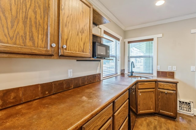 849 39th St, Des Moines, IA 50312 - kitchen with crown molding, brown cabinetry, black appliances, and recessed lighting
