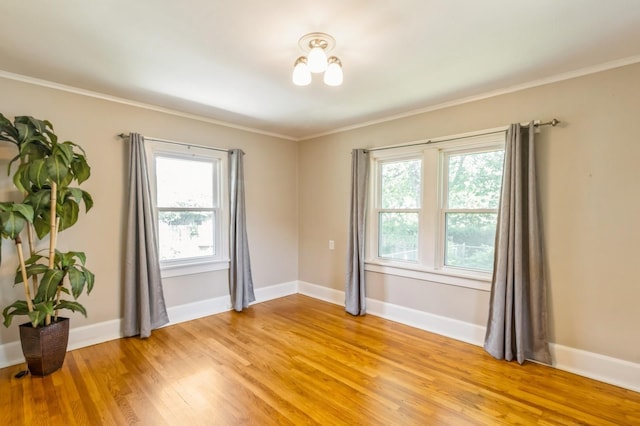 849 39th St, Des Moines, IA 50312 - unfurnished room featuring light wood-style floors, plenty of natural light, and crown molding