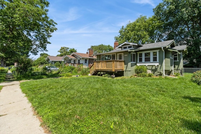849 39th St, Des Moines, IA 50312 - view of front facade featuring a deck, a front yard, and a chimney