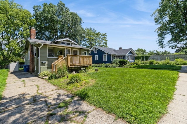849 39th St, Des Moines, IA 50312 - view of front of home with a wooden deck and a chimney