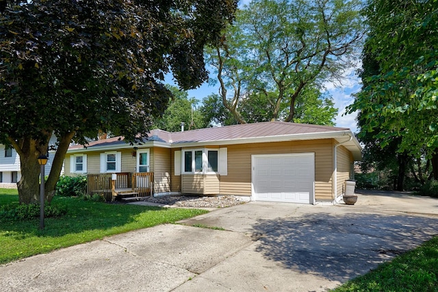 1612 Horse N Buggy Dr, Adel, IA 50003 - ranch-style home featuring an attached garage, driveway, a front yard, and a metal roof