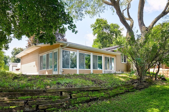 1612 Horse N Buggy Dr, Adel, IA 50003 - back of house featuring a sunroom