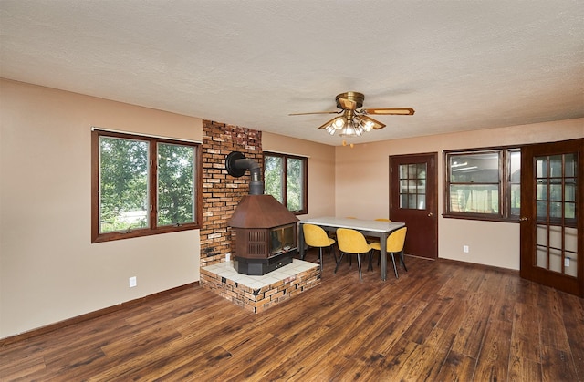 1612 Horse N Buggy Dr, Adel, IA 50003 - dining area with a wood stove, wood finished floors, a ceiling fan, and a textured ceiling