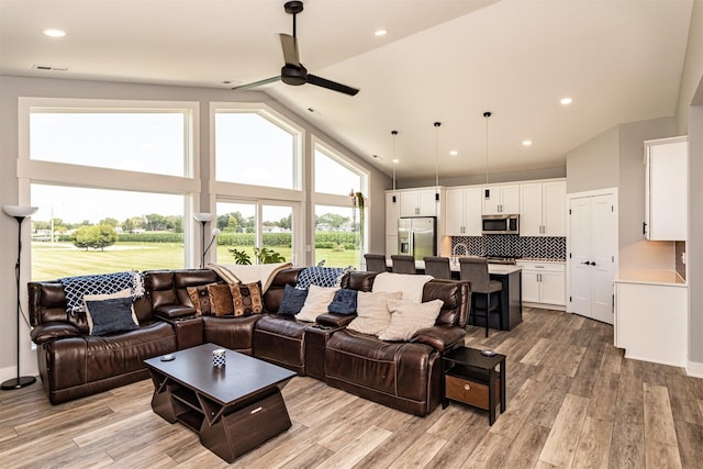 409 S St, Jewell, IA 50130 - living area with a ceiling fan, light wood-type flooring, plenty of natural light, high vaulted ceiling, and recessed lighting