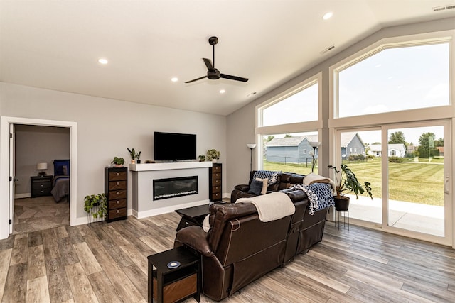 409 S St, Jewell, IA 50130 - living area featuring a ceiling fan, healthy amount of natural light, light wood finished floors, a glass covered fireplace, and recessed lighting