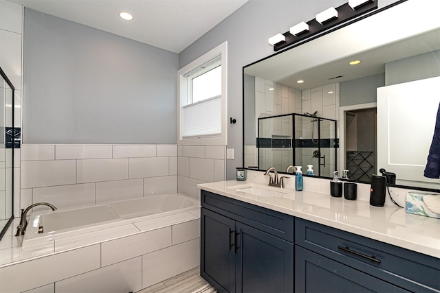 409 S St, Jewell, IA 50130 - full bath featuring a bath, a shower stall, vanity, and recessed lighting