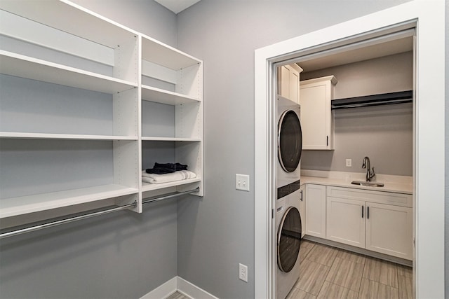 409 S St, Jewell, IA 50130 - washroom featuring cabinet space and stacked washer / dryer