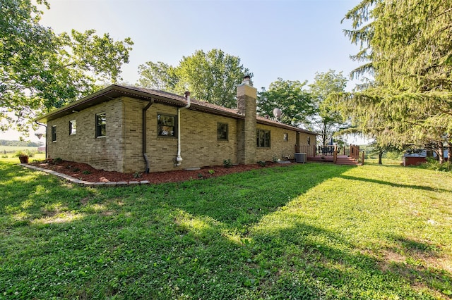 122 G76 Hwy, Lacona, IA 50139 - rear view of house featuring a wooden deck, a yard, a chimney, and brick siding