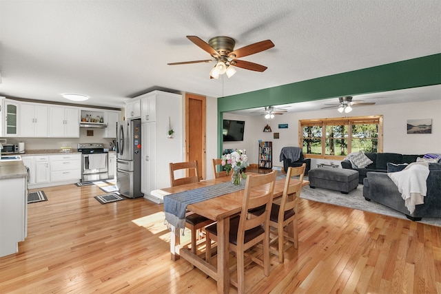 122 G76 Hwy, Lacona, IA 50139 - dining room featuring light wood-type flooring and a ceiling fan