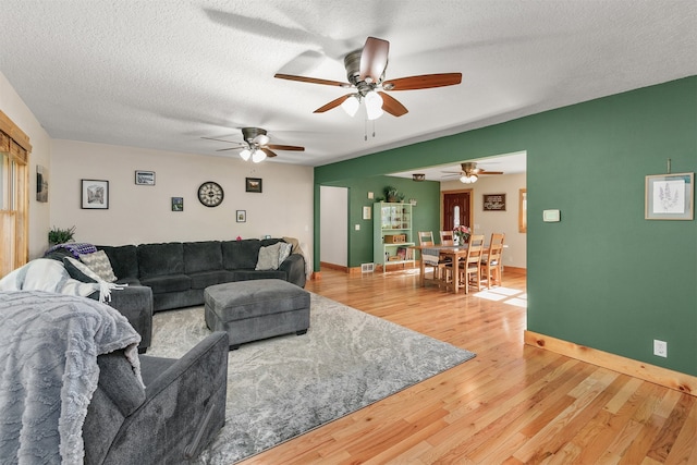 122 G76 Hwy, Lacona, IA 50139 - living area with ceiling fan, light wood-type flooring, and a textured ceiling