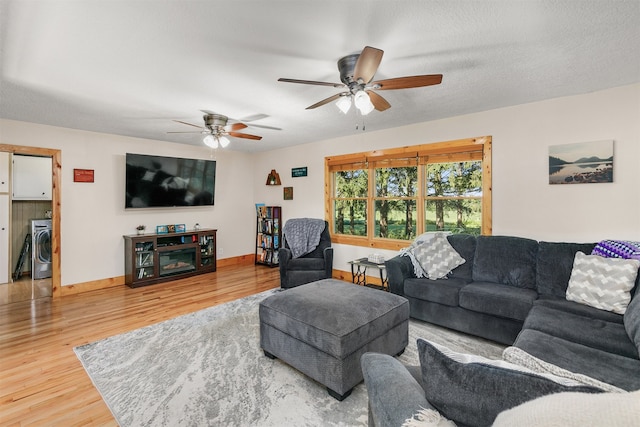 122 G76 Hwy, Lacona, IA 50139 - living room featuring washer / clothes dryer, wood finished floors, and ceiling fan