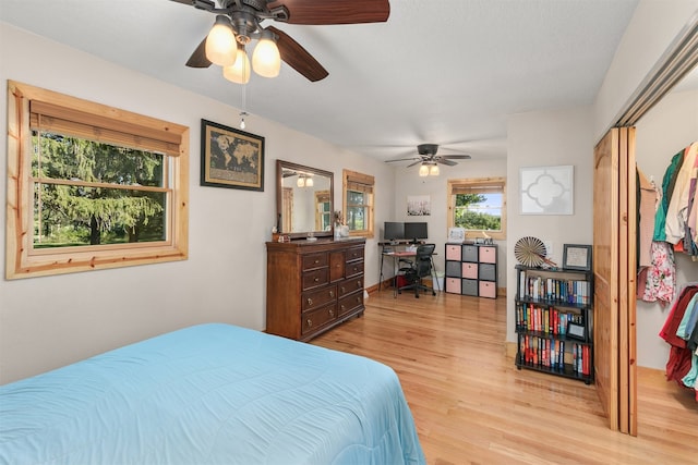 122 G76 Hwy, Lacona, IA 50139 - bedroom with light wood finished floors, a desk, and a ceiling fan