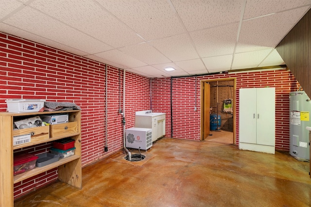 122 G76 Hwy, Lacona, IA 50139 - finished basement with a paneled ceiling, electric water heater, and brick wall