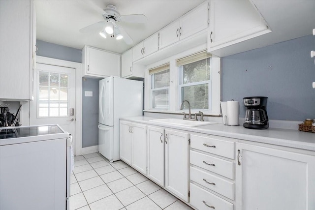 616 4th St, West Des Moines, IA 50265 - kitchen with range, freestanding refrigerator, light tile patterned floors, white cabinets, and a ceiling fan