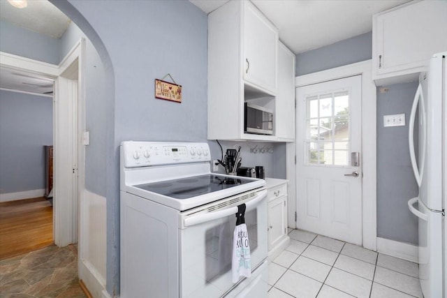 616 4th St, West Des Moines, IA 50265 - kitchen featuring white appliances, arched walkways, white cabinets, and light countertops