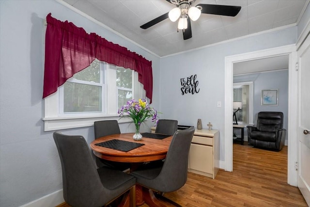 616 4th St, West Des Moines, IA 50265 - dining room with light wood-style floors, ornamental molding, and a ceiling fan