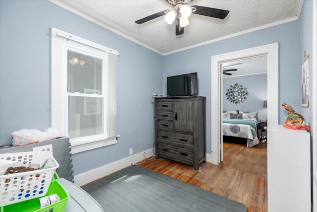 616 4th St, West Des Moines, IA 50265 - bedroom featuring wood finished floors, ornamental molding, a textured ceiling, and ceiling fan
