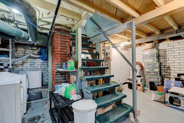 616 4th St, West Des Moines, IA 50265 - unfinished below grade area featuring washing machine and clothes dryer, stairway, and brick wall