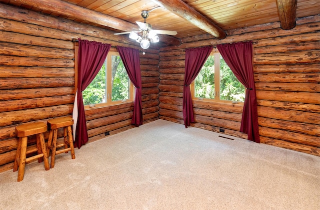 702 Jasper Ave NE, Mitchellville, IA 50169 - empty room featuring plenty of natural light, a wooden ceiling with exposed beams, carpet, a ceiling fan, and log walls