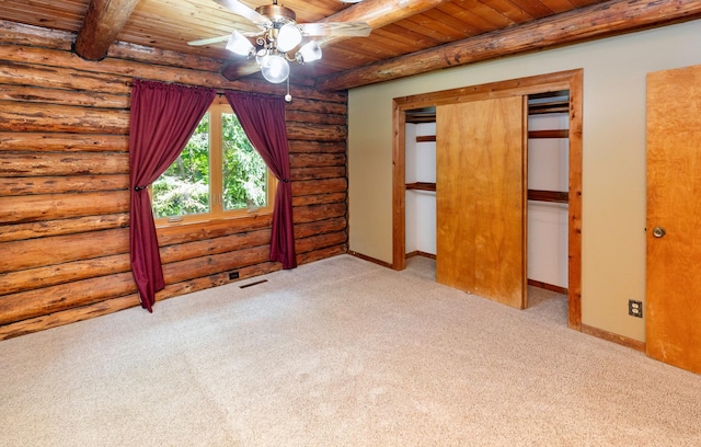 702 Jasper Ave NE, Mitchellville, IA 50169 - unfurnished bedroom with log walls, carpet flooring, a wooden ceiling with exposed beams, and ceiling fan
