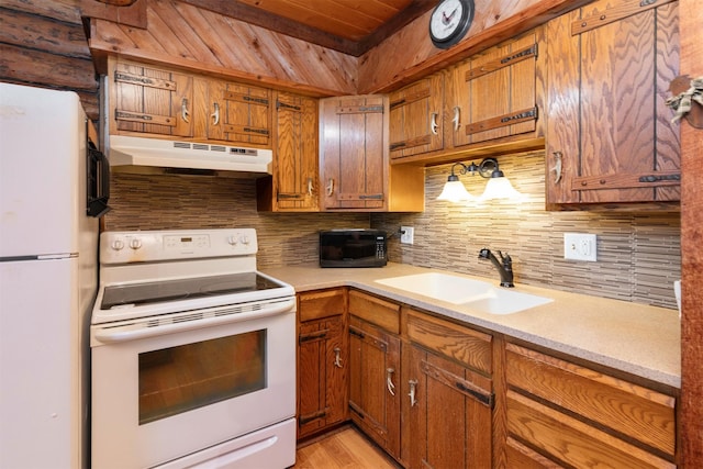 702 Jasper Ave NE, Mitchellville, IA 50169 - kitchen featuring under cabinet range hood, white appliances, wooden ceiling, light countertops, and decorative backsplash