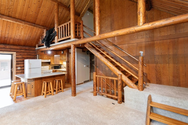 702 Jasper Ave NE, Mitchellville, IA 50169 - unfurnished living room featuring lofted ceiling, light carpet, wooden ceiling, and log walls